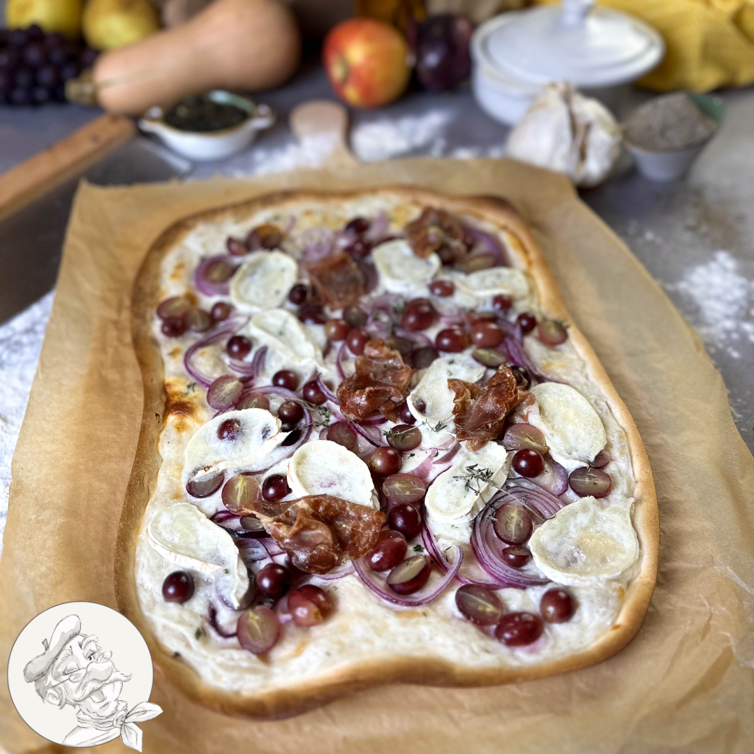 Tarte flambée with grapes, goat cheese and coppa